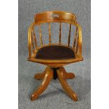 A late 19th century revolving oak desk chair with leather upholstery.