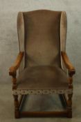 Wing back armchair, mid 20th century in the antique oak style. H.108cm.