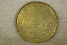 Brass plate with Egyptian relief decoration and a star at the centre. Diameter of 50 cm.