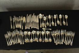 A large collection of silver plated cutlery to include spoons, and knifes and forks decorated with