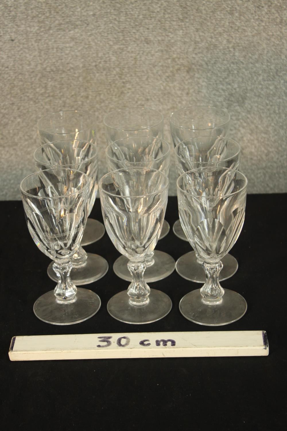 A set nine early 20th century faceted drinking glasses with central knop stem, raised on circular - Image 2 of 2