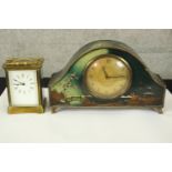 A mantel and carriage clock. The carriage clock with glass sides and exposed working. The mantle