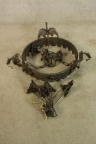 An iron "dragon" chandelier. Gothic in style. Complete with its ceiling chain and candle holders.