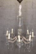A French Chandelier draped with crystal glass teardrop and eight branches of lights. H.86 x W.60 cm.