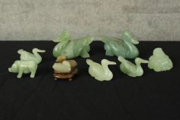 A collection of jade. Eight animals and one buddha. A mix of swans, ducks and pigs. The largest