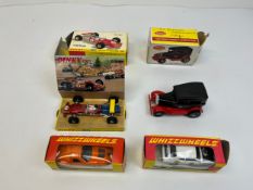 A collection of four Dinky toys cars including ‘Whizzwheels’ and the Lotus F1 Racing Car.
