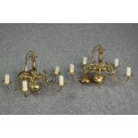 A matching pair of brass chandeliers. Each with five branches. One branch missing its candle