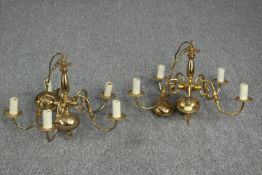 A matching pair of brass chandeliers. Each with five branches. One branch missing its candle