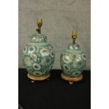 Two teal ceramic table lamps. With hand painted floral decoration and delicate gilt detailing. The
