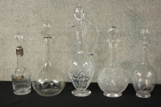 A collection of five 19th century hand etched crystal and glass decanters, including one with a