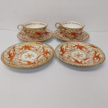 Four 19th century hand painted and gilded scrolling foliate design porcelain saucers and two