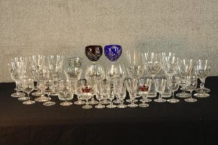 A large assorted collection of vintage cut and moulded drinking glasses together with two coloured