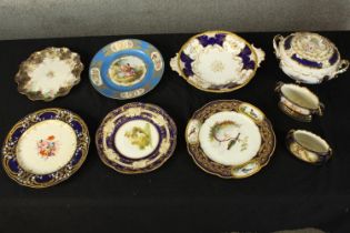 An assortment of decorative terrines and plates. A mix of styles and shapes, some with scalloped
