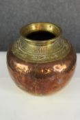A pot made of brass and copper. The brass with an engraved pattern. H.17 x Dia.17 cm.
