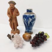 Two bunches of decorative grapes, one made of rose quartz along with a blue and white Chinese vase
