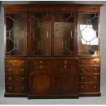 A Georgian style mahogany breakfront library bookcase, in two sections. H.227 W.238cm.