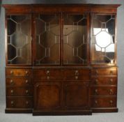 A Georgian style mahogany breakfront library bookcase, in two sections. H.227 W.238cm.