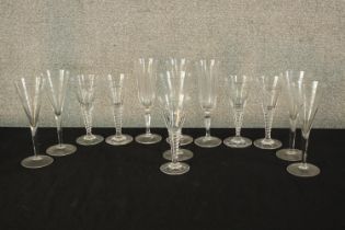 Thirteen assorted 20th century drinking glasses, some with air twist stems. H.21 cm. (largest)