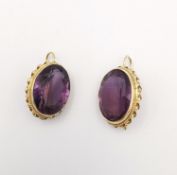 A pair of 14 carat yellow gold amethyst drop earrings. The pair set with a combined carat weight