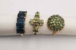 Three 20th century 9 carat gold gem-set rings, a blue five stone ring, a green stone bombe cluster