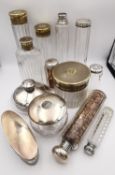 A collection of thirteen silver lidded dressing table bottles and pots. A set of four with