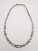 A vintage white metal (tests as 18ct white gold) and diamond herringbone necklace. The necklace