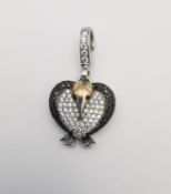 A Theo Fennell 18ct white and yellow gold diamond 'ART' penguin pendant. The pendant set with