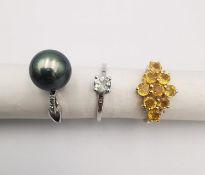 Three 20th century 9 carat gold gem-set rings, a black cultured pearl ring (pearl detached), a
