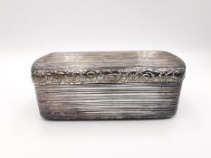 A Georgian Sterling silver snuff box with raised ridged and floral design, gilded to interior.