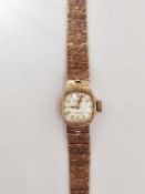 A ladies 1970's 9ct gold Rotary automatic cocktail watch. It has an articulated bark textured