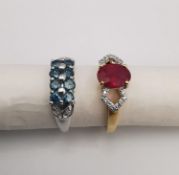 Two 20th century 18ct carat gold gem-set rings. A ruby and diamond flanked solitaire ring set to