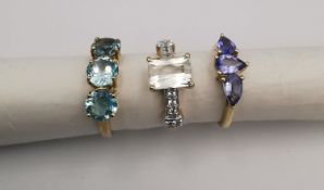 Three 20th century 9 carat gold gem-set rings, a three stone tanzanite ring, a three stone