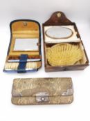 Two silver dressing sets and a python coin purse with silver mounts. The dressing sets contain