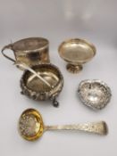 A collection of silver to include an engraved foliate design sugar spoon, a lidded mustard pot and