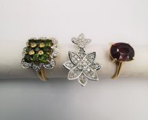 Three 20th century 9 carat gold gem-set rings, a white gold diamond set double flower design ring