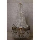 A large early 20th century basket chandelier, gilt metal and crystal drops. H.110 Dia.65cm.