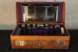 A late 19th/early 20th century gentlemans vanity set in a brown leather suitcase fitted with a