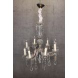 A crystal chandelier with eight batches of lights and draped in teardrop glass. H.86 x W.60 cm.