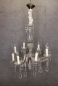 A crystal chandelier with eight batches of lights and draped in teardrop glass. H.86 x W.60 cm.