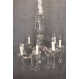 Brass chandelier with glass teardrop decoration and eight branches of lights. H.77 x W.68 cm.