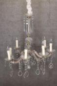 Brass chandelier with glass teardrop decoration and eight branches of lights. H.77 x W.68 cm.