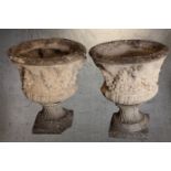 A pair of concrete planters decorated with classical floral relief. Each measuring H.69 x Dia. 59