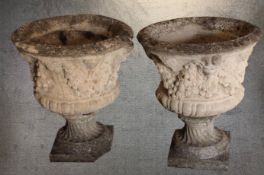 A pair of concrete planters decorated with classical floral relief. Each measuring H.69 x Dia. 59