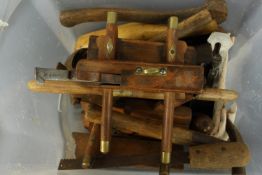 A box of old woodwork tools including an edging planer with brass fittings. The largest measures L.