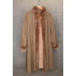 A ladies coat lined and edged in rabbit fur.