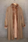 A ladies coat lined and edged in rabbit fur.