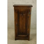 Side cabinet, carved oak in the antique style with maker's label. H.85 W.40cm.
