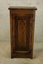 Side cabinet, carved oak in the antique style with maker's label. H.85 W.40cm.