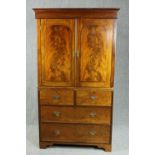 Linen press, early 19th century flame mahogany, in two sections. H.202 W.117 D.58cm.