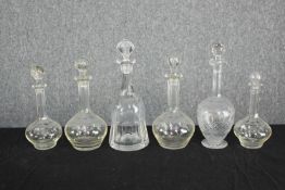 A mixed collection of decanters complete with their lids. Four 19th century with matching etched